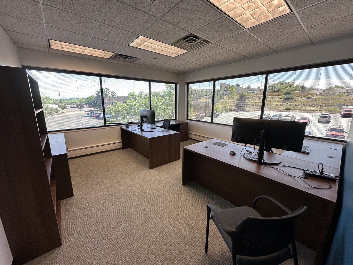 Corner team office with two workstations and windows at ORBIT